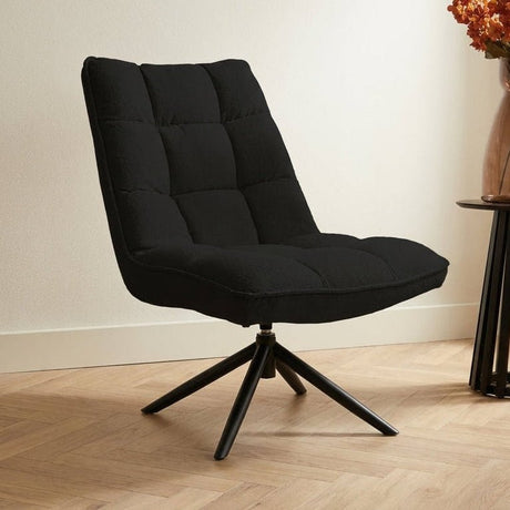 Poltrona girevole Yuki Black Bouclé Ruotabile a 360° Foto suggestiva in un interno moderno