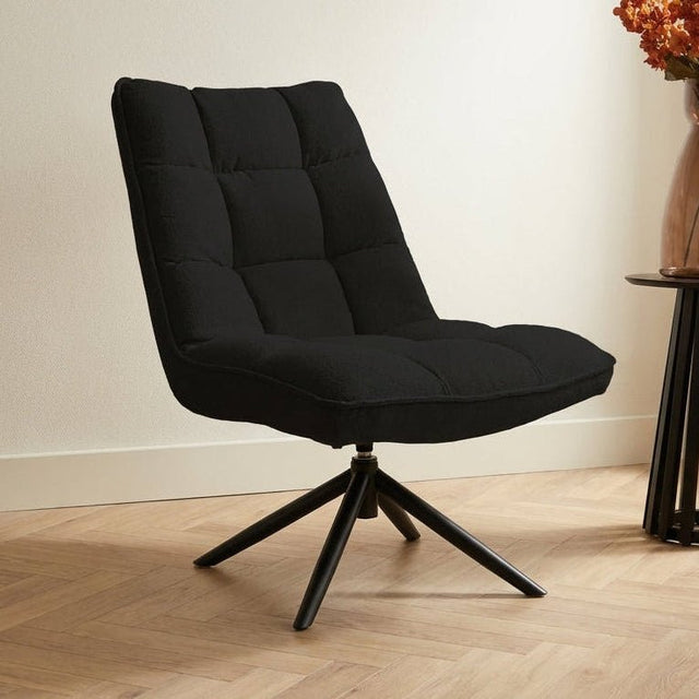 Poltrona girevole Yuki Black Bouclé Ruotabile a 360° Foto suggestiva in un interno moderno